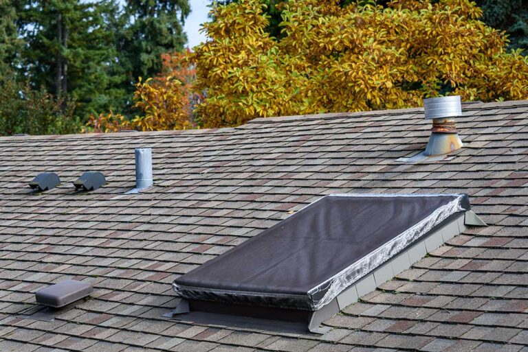 Close view of vented soffit panels and painted fascia beneath a residential roof eave.